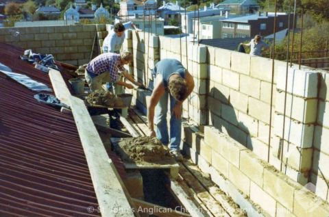 Block laying on dome parapet - 70 year old temporary roof visible on left