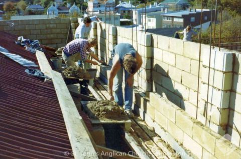 Block laying on dome parapet - 70 year old temporary roof visible on left