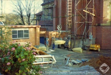 Corner block being lifted and roof top assembly awaiting lifting